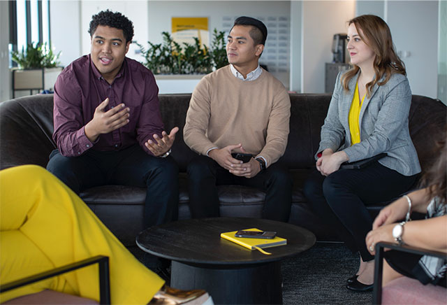 Western Union staff members talking together in a meeting